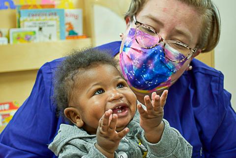 LOCATE Child Care 3 Happy baby with child care provider.