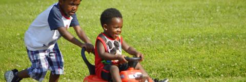 Children playing with a buggy