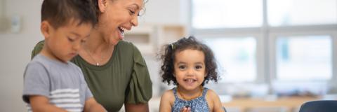 Prosolutions Child care provider and children joyously learning together.