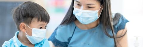Masked provider and toddler. Masked provider and toddler.