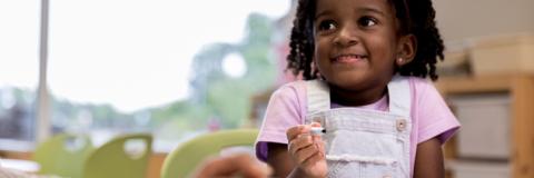 Child Care Scholarship Info Little girl smiling at child care.
