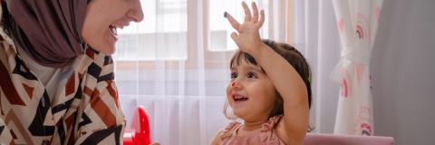 Responsive Training 2023 Little girl and child care provider coloring together