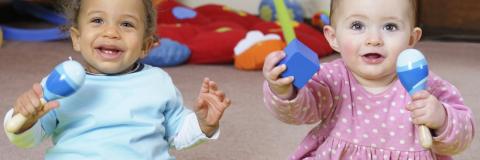 Babies love the beat. Two babies enjoying themselves playing music.