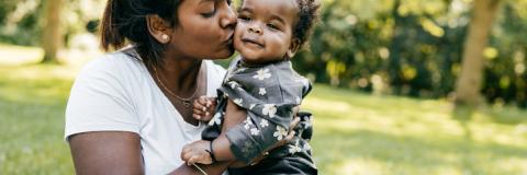 Mom enjoying outdoor time with baby daughter
