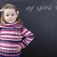 Little girl in front of blackboard