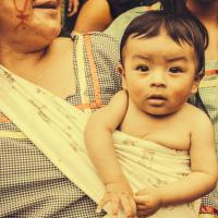 Baby in a sling with mom in Amazonia. 