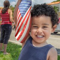 Happy toddler with an American flag.