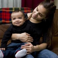 Young mom and her son smile. 