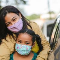 Masked mom and young girl. 