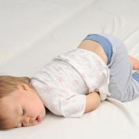 Baby sleeping with her bottom up.