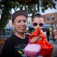 Young parents and toddler girl in sunglasses.