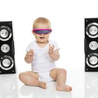 Baby with sunglasses and large speakers. 