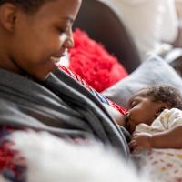 Mom breastfeeding her daughter. 