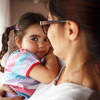 Mom holding daughter.