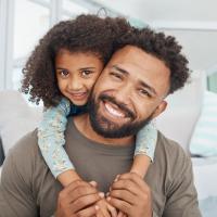 Father and his little daughter relaxing together at home .