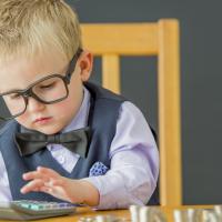 Little boy playing accountant. 