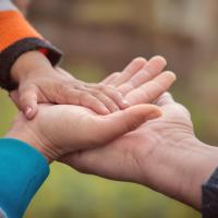 Stacked hands - father, mother, baby.