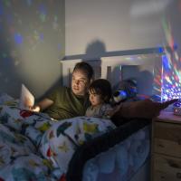 Dad reading a bedtime story to his son.