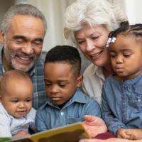 Grandparents telling stories to their three grandchildren. 