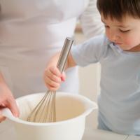 Preschooler helping his father with Thanksgiving dinner. 