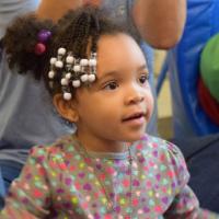 African-American toddler girl with ponytail and hair beads 