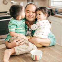 Kids hugging a father 