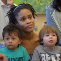 Diversity is key - two small boys sitting on woman's lap 