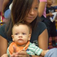 Young girl with small child in her arms 