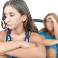 worried and thoughtful teenage girl with her mother at home 