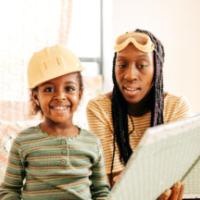 Mom and daughter reading a book 