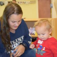 Mother and baby work on a task together 