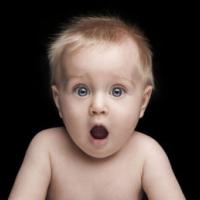Infant portrait with funny shocked face expression 