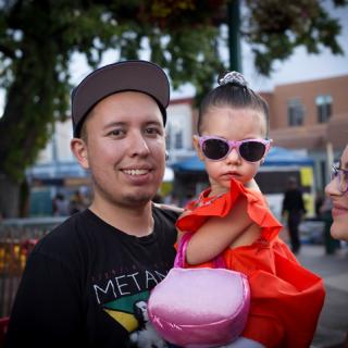 Young parents and toddler girl in sunglasses. 