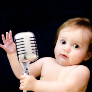 Baby with a microphone. 