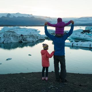 Dad and children watching the polar ice caps melt. 