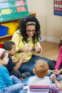 Coaching and Mentoring Teacher giving students a thumbs up.