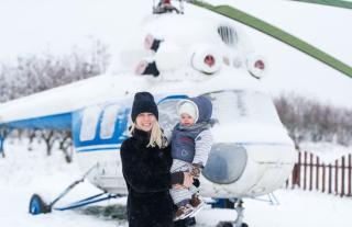 Mom with toddler near a helicopter in the snow. The Respectful Approach to Parenting