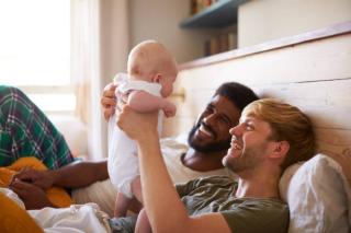 Two dads and their baby. Time to Care 2021