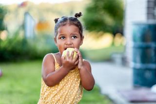 An Apple a Day Little girl eating an apple.