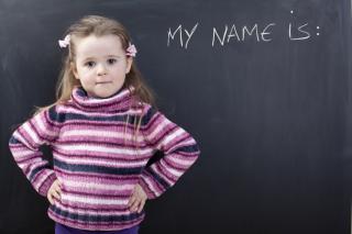 Little girl in front of blackboard
