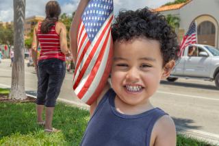 Happy toddler with an American flag.