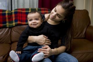 Young mom and her son smile. 