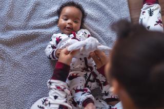 Happy baby boy in pajamas with dad.