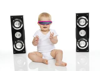 Baby with sunglasses and large speakers. 