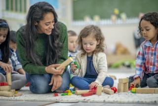 Pre-K teacher and female student