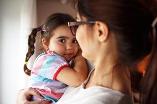 Mom holding daughter.