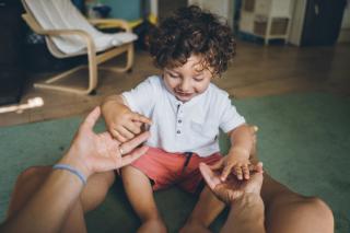 America Has a Decision to Make Toddler taking his teacher's hands.