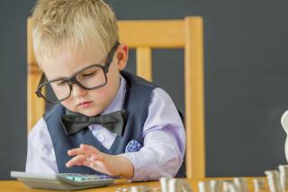 Little boy playing accountant. 