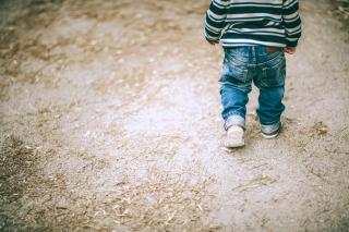 Toddler walking by himself.