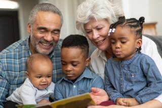 Grandparents telling stories to their three grandchildren. 